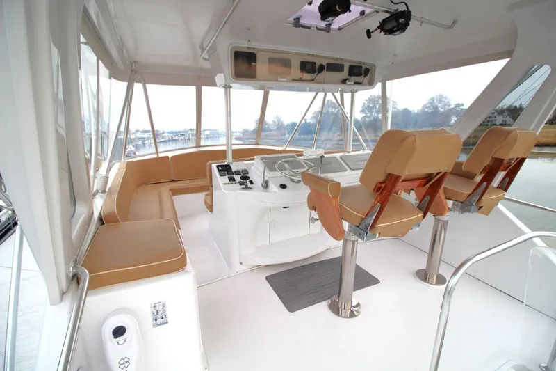 Slide: The Image of 1999 Ocean Yachts 60 Super Sport yacht interior with helm and seating area. - 23