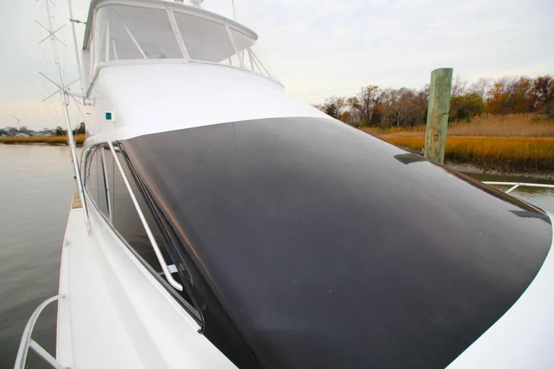 Slide: The Image of 1999 Ocean Yachts 60 Super Sport boat docked by marshland. - 37