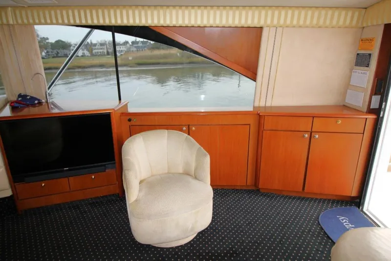 Slide: The Image of Interior of 1999 Ocean Yachts 60 Super Sport with chair, TV, and cabinets. - 39