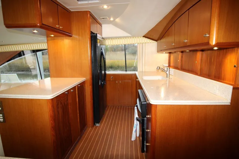 Slide: The Image of Luxurious kitchen interior of 1999 Ocean Yachts 60 Super Sport with wood cabinetry and modern appliances. - 43