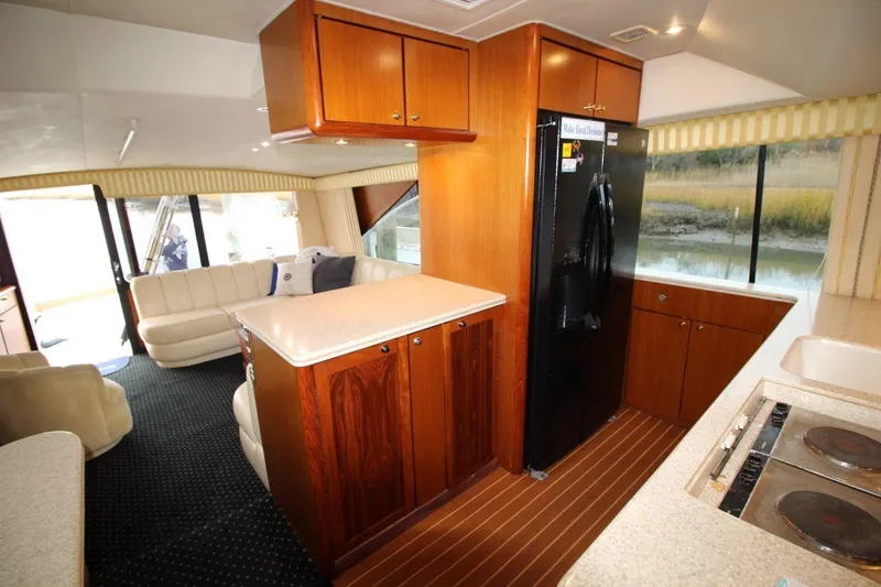 Slide: The Image of Interior of 1999 Ocean Yachts 60 Super Sport with kitchen and seating area. - 44