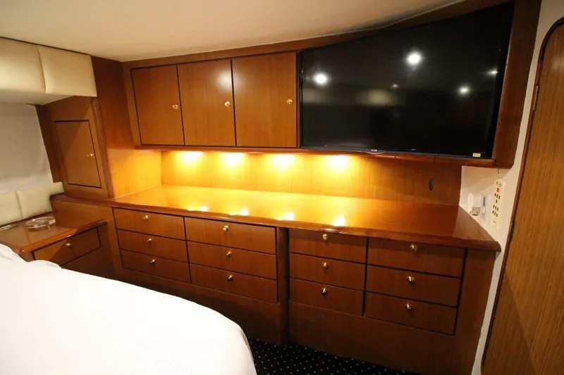 Slide: The Image of Luxurious cabin interior of 1999 Ocean Yachts 60 Super Sport with wood cabinetry and TV. - 48