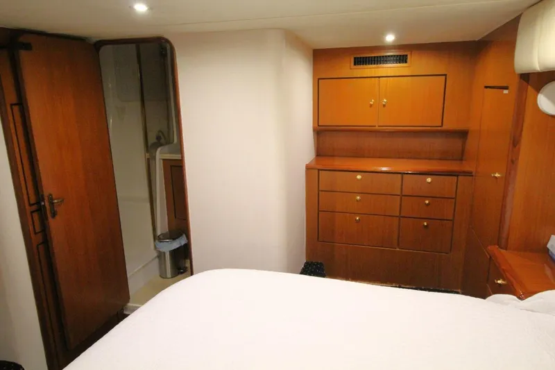 Slide: The Image of 1999 Ocean Yachts 60 Super Sport cabin with wooden cabinetry and ensuite bathroom. - 49