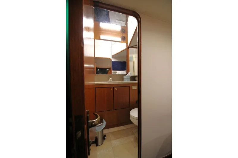 Slide: The Image of Bathroom interior of 1999 Ocean Yachts 60 Super Sport, featuring wooden cabinetry and modern fixtures. - 52