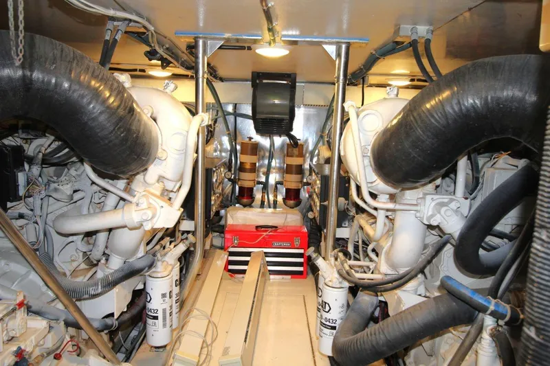 Slide: The Image of Engine room of 1999 Ocean Yachts 60 Super Sport with visible machinery and equipment. - 61