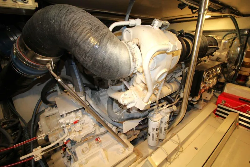 Slide: The Image of Engine room of a 1999 Ocean Yachts 60 Super Sport, showcasing mechanical components. - 63