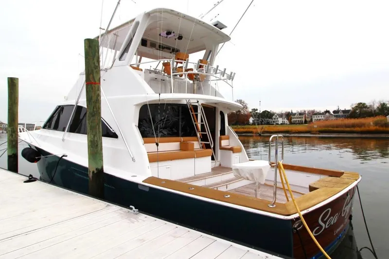 Slide: The Image of 1999 Ocean Yachts 60 Super Sport docked, showcasing elegant design and spacious deck. - 1