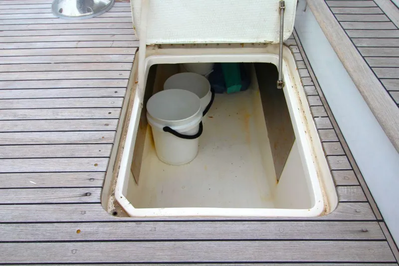 Slide: The Image of Open storage compartment on 1999 Ocean Yachts 60 Super Sport with buckets inside. - 17