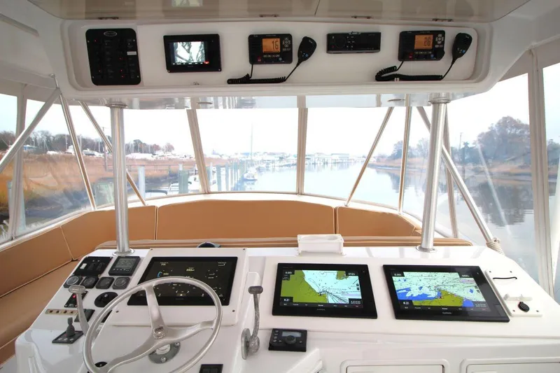 Slide: The Image of Cockpit of 1999 Ocean Yachts 60 Super Sport with navigation screens and controls. - 26
