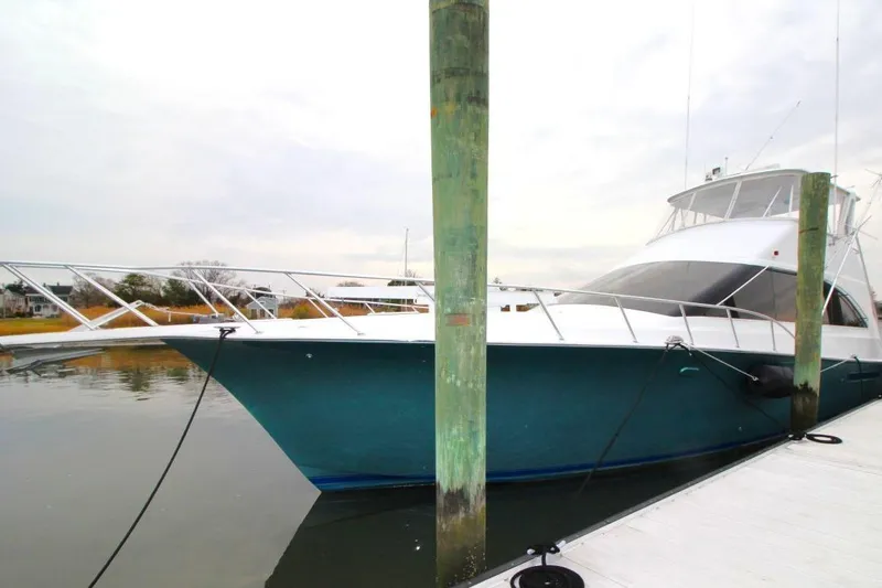 Slide: The Image of 1999 Ocean Yachts 60 Super Sport docked, showcasing sleek design and spacious deck. - 3