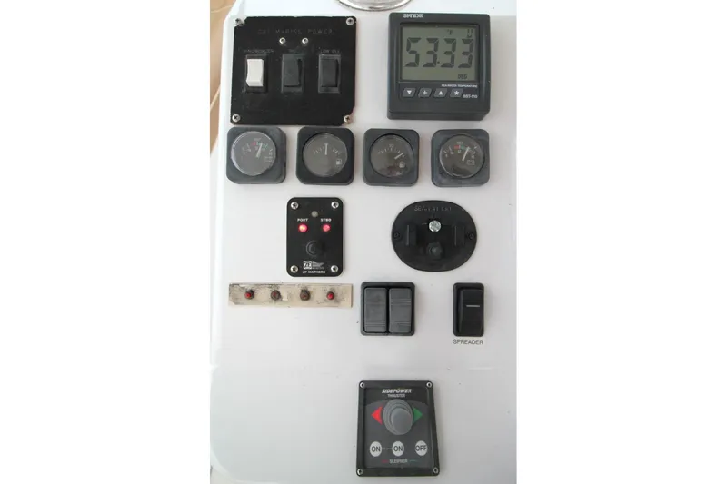 Slide: The Image of Control panel of a 1999 Ocean Yachts 60 Super Sport with various gauges and switches. - 32