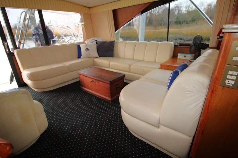 Slide: The Image of Luxurious interior of 1999 Ocean Yachts 60 Super Sport with cream leather seating and wooden accents. - 40