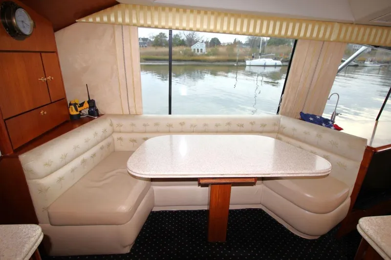 Slide: The Image of 1999 Ocean Yachts 60 Super Sport interior with dining area and waterfront view. - 42