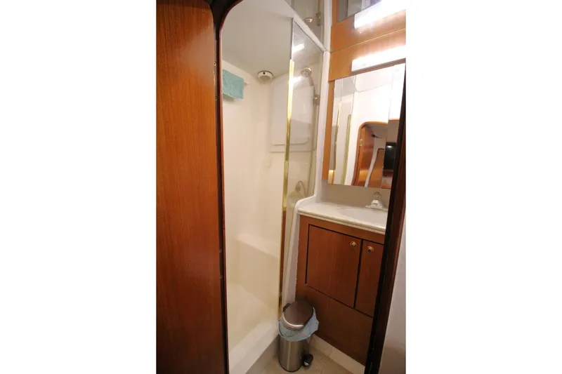 Slide: The Image of Bathroom interior of 1999 Ocean Yachts 60 Super Sport with shower and wooden cabinetry. - 51