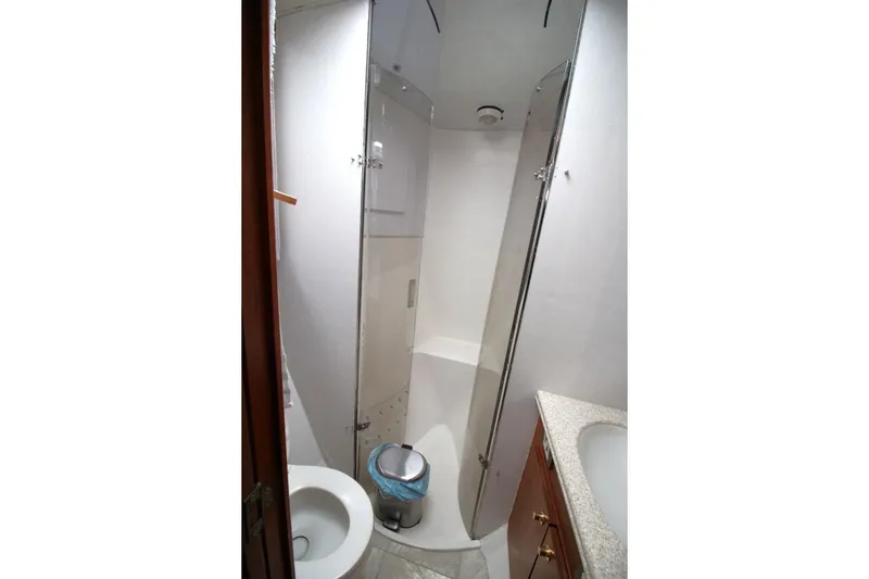 Slide: The Image of Bathroom interior of 1999 Ocean Yachts 60 Super Sport, featuring shower and sink. - 59