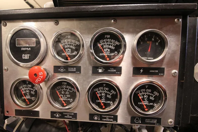 Slide: The Image of Instrument panel of a 1999 Ocean Yachts 60 Super Sport, featuring various gauges and controls. - 65