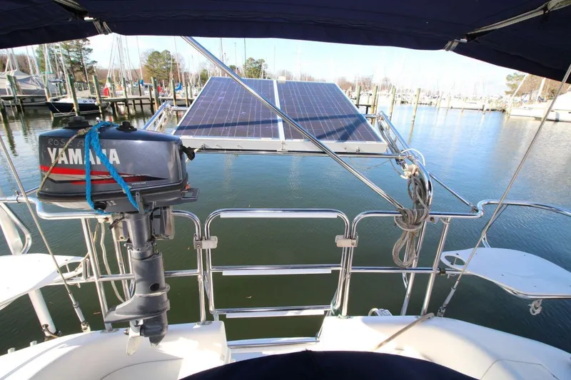 Slide: The Image of Catalina 320 sailboat with Yamaha motor and solar panels, docked in a marina. - 16