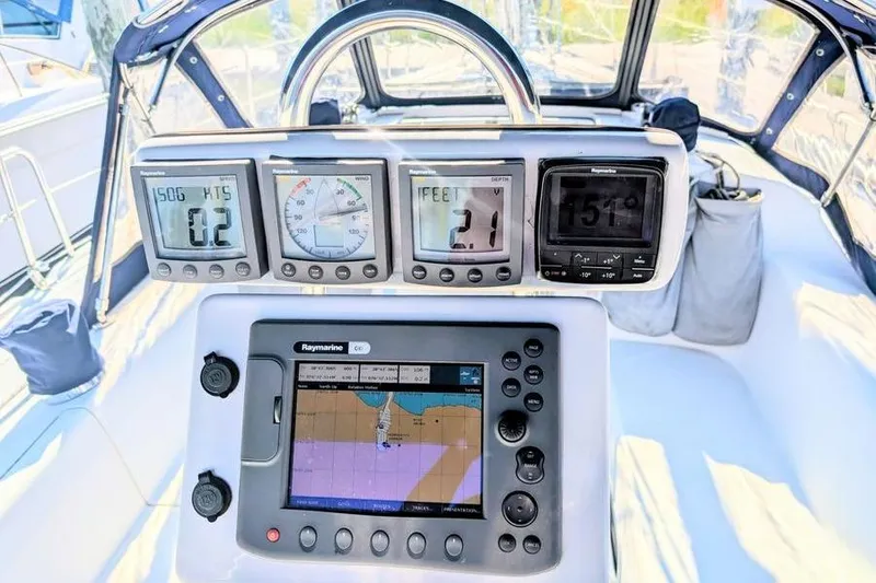 Slide: The Image of Cockpit of 2003 Catalina 320 sailboat with navigation instruments and Raymarine display. - 17