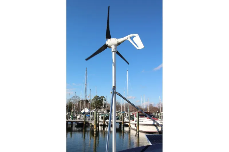 Slide: The Image of Wind turbine on a 2003 Catalina 320 sailboat at a marina, clear blue sky. - 19