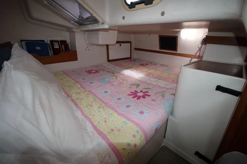 Slide: The Image of Cozy cabin interior of a 2003 Catalina 320 sailboat with floral bedding. - 27