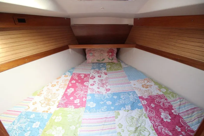 Slide: The Image of Cozy cabin interior of 2003 Catalina 320 sailboat with colorful floral bedding. - 28