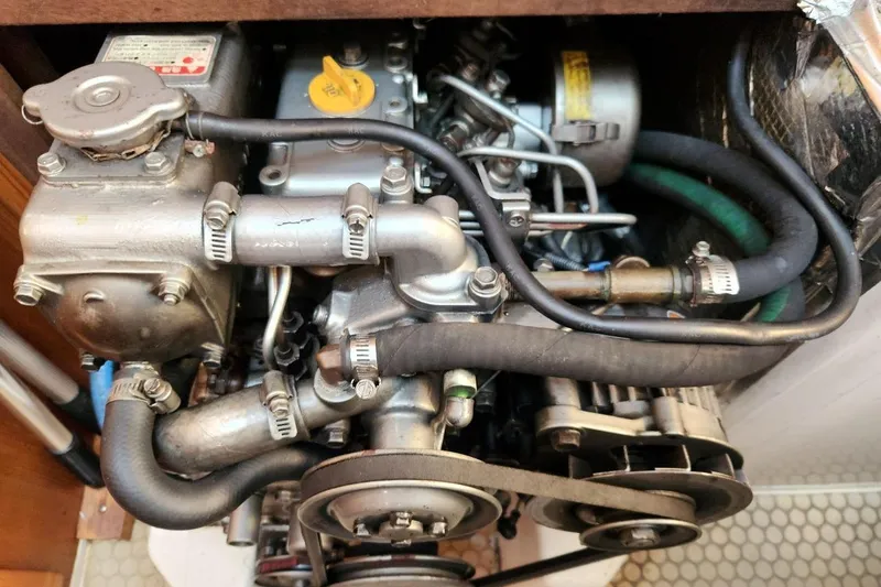 Slide: The Image of Engine of a 2003 Catalina 320 sailboat, showcasing detailed mechanical components. - 31