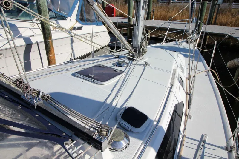 Slide: The Image of 2003 Catalina 320 sailboat deck with rigging and hatches, docked at marina. - 9