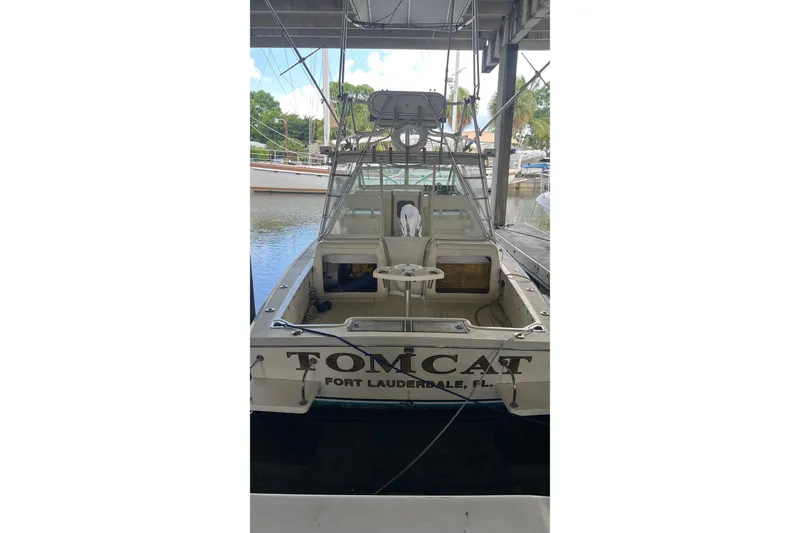 Slide: The Image of 1968 Bertram 31 Bahia Mar boat docked, rear view, labeled "Tomcat" in Fort Lauderdale. - 10
