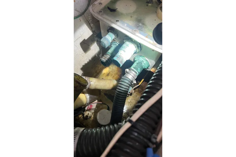 Slide: The Image of Bilge area of a 1968 Bertram 31 Bahia Mar with visible hoses and fittings. - 15