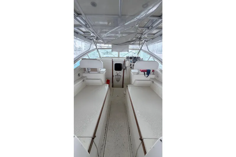 Slide: The Image of 1968 Bertram 31 Bahia Mar boat interior with white seating and helm controls. - 17