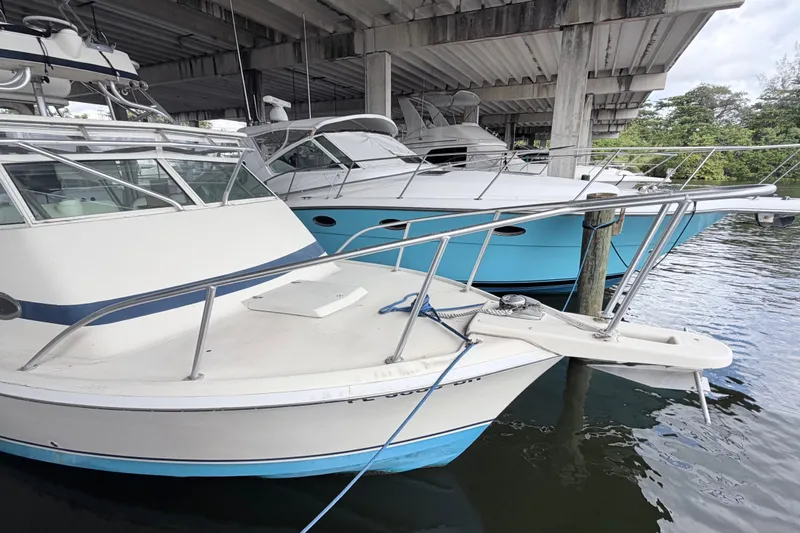 Slide: The Image of 1968 Bertram 31 Bahia Mar docked under a bridge, alongside other boats. - 18