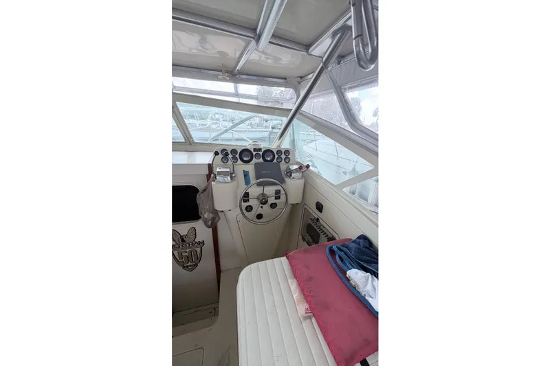 Slide: The Image of Interior of a 1968 Bertram 31 Bahia Mar boat, featuring a classic helm and seating area. - 19