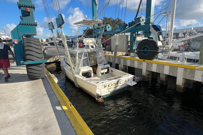 Slide: The Image of 1968 Bertram 31 Bahia Mar boat docked at marina with blue sky background. - 2