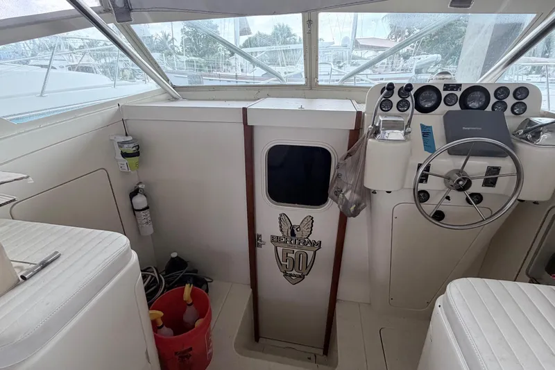 Slide: The Image of 1968 Bertram 31 Bahia Mar boat cockpit with steering wheel and control panel. - 20