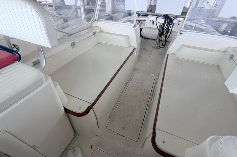Slide: The Image of Interior of a 1968 Bertram 31 Bahia Mar boat, featuring seating and storage areas. - 21