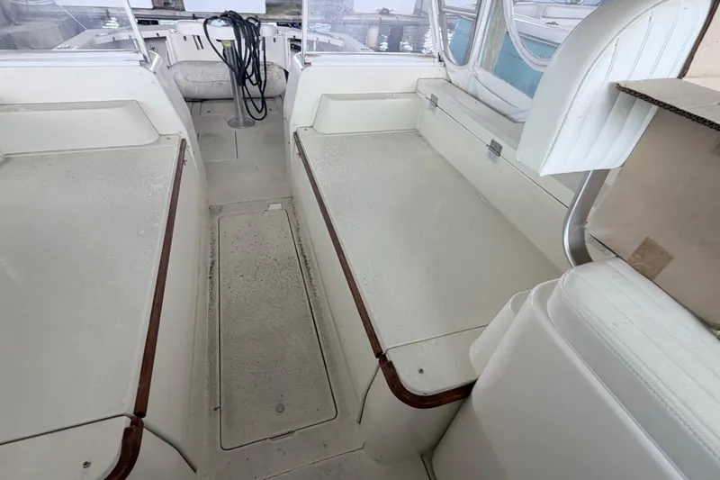 Slide: The Image of Interior of a 1968 Bertram 31 Bahia Mar boat, featuring white seating and clean design. - 22