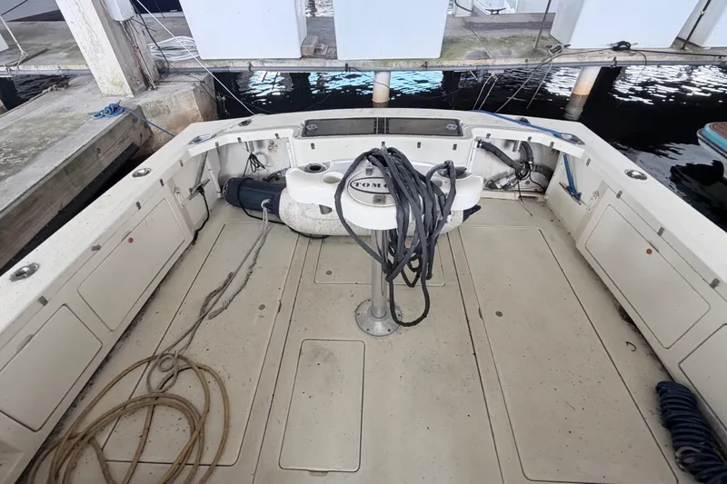 Slide: The Image of 1968 Bertram 31 Bahia Mar boat deck with ropes and equipment at a dock. - 23