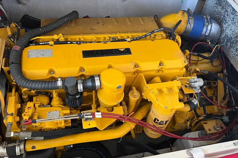 Slide: The Image of Yellow engine of a 1968 Bertram 31 Bahia Mar boat, featuring CAT components. - 8