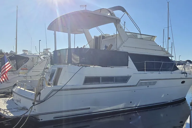 The Image of 1995 Carver 430 Cockpit Motor Yacht docked in sunny marina. - 0