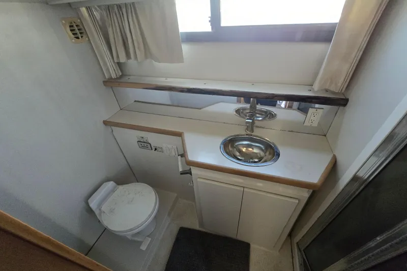 Slide: The Image of Bathroom interior of 1995 Carver 430 Cockpit Motor Yacht with sink and toilet. - 26
