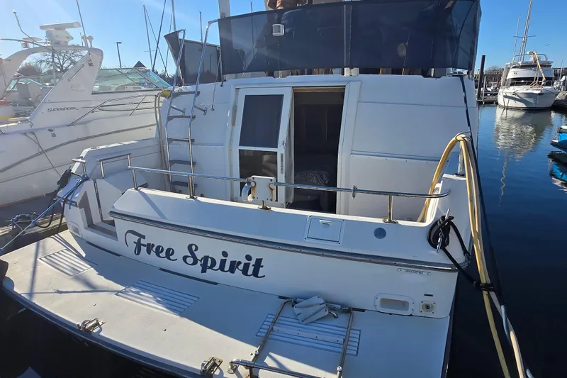 Slide: The Image of 1995 Carver 430 Cockpit Motor Yacht "Free Spirit" docked at marina. - 28