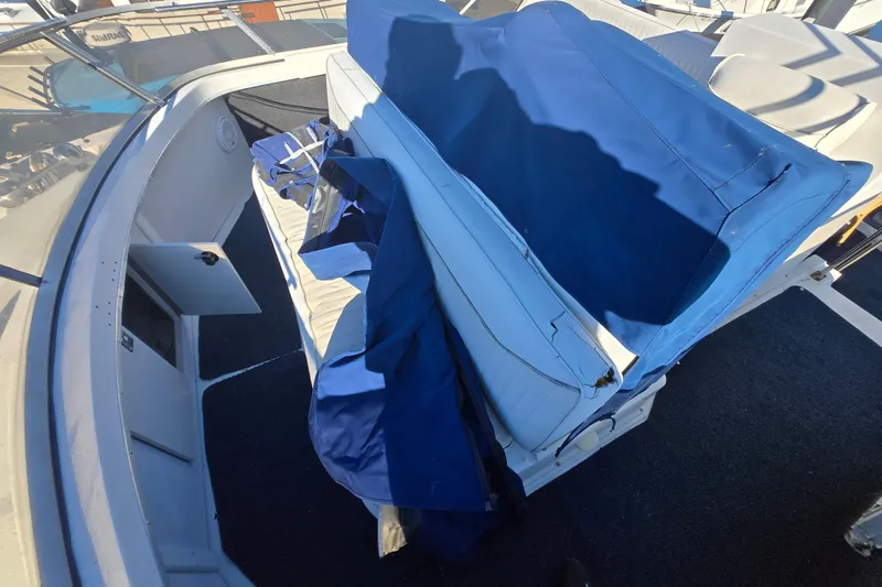 Slide: The Image of 1995 Carver 430 Cockpit Motor Yacht interior with blue seating and open storage compartment. - 29