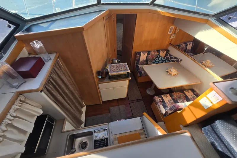 Slide: The Image of Interior of 1995 Carver 430 Cockpit Motor Yacht with dining area and kitchenette. - 3