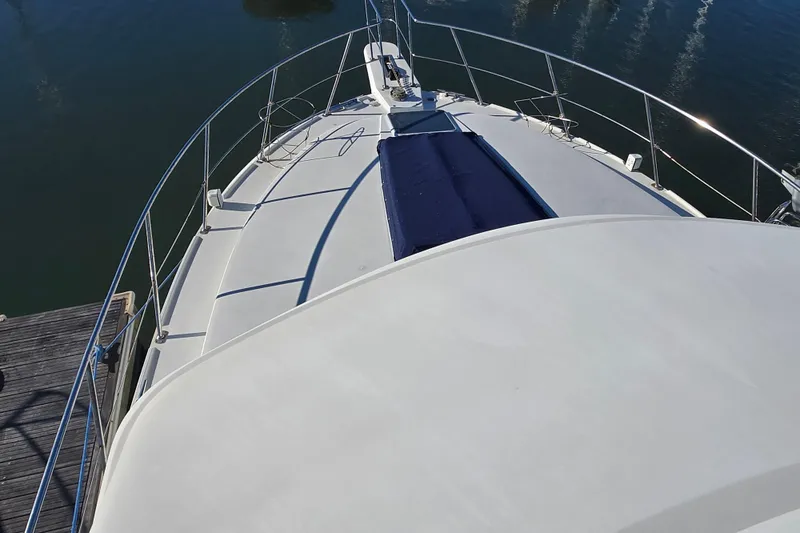 Slide: The Image of 1995 Carver 430 Cockpit Motor Yacht deck view with railing and blue cover. - 31