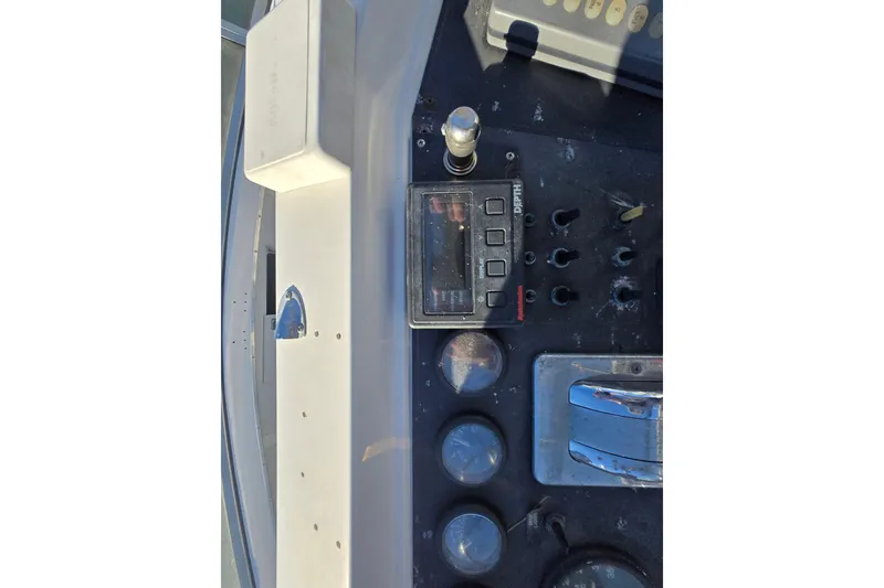 Slide: The Image of Control panel of a 1995 Carver 430 Cockpit Motor Yacht with gauges and switches. - 37