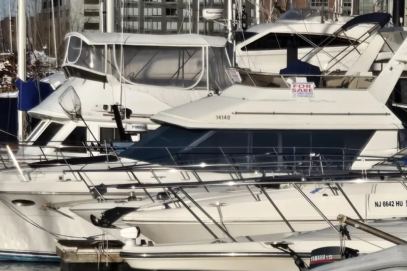 Slide: The Image of 1995 Carver 430 Cockpit Motor Yacht for sale at marina, surrounded by other boats. - 46