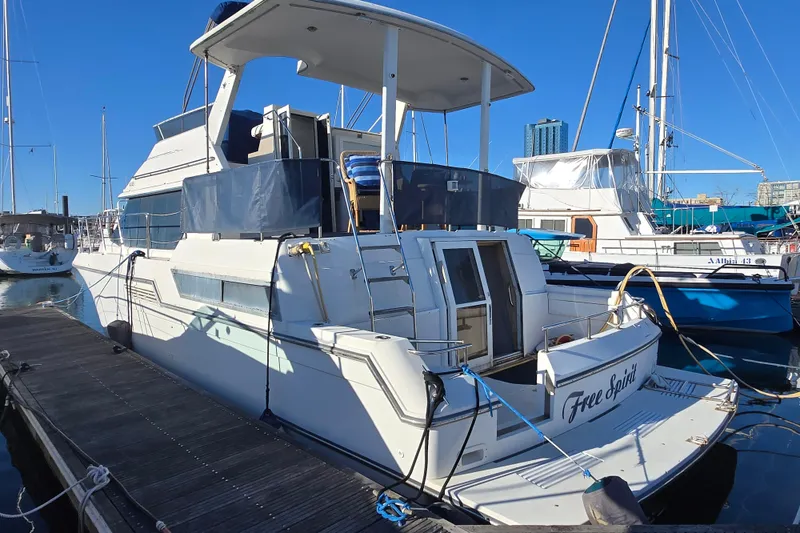 Slide: The Image of 1995 Carver 430 Cockpit Motor Yacht docked at marina, sunny day. - 5