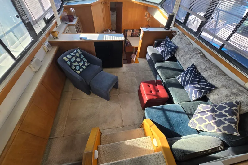 Slide: The Image of Interior of 1995 Carver 430 Cockpit Motor Yacht with cozy seating and decorative pillows. - 7