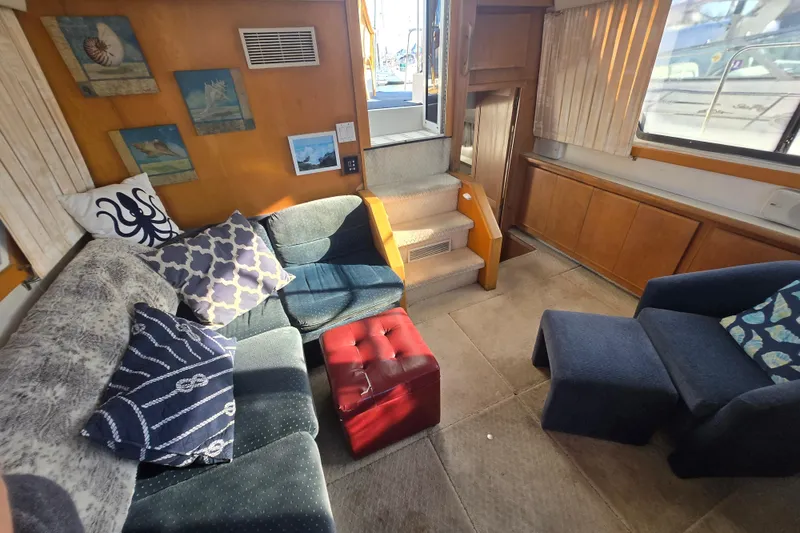 Slide: The Image of Interior of 1995 Carver 430 Cockpit Motor Yacht with cozy seating and nautical decor. - 9