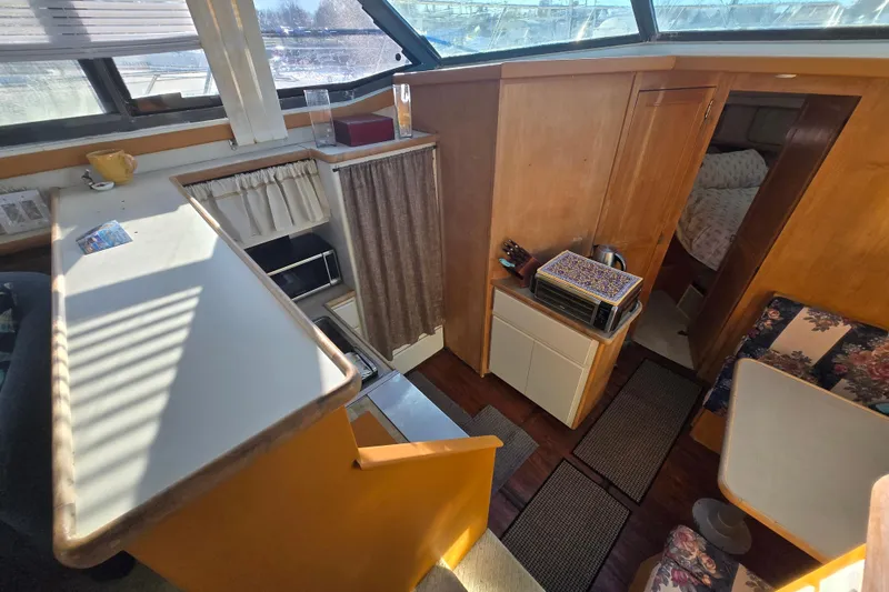 Slide: The Image of Interior of 1995 Carver 430 Cockpit Motor Yacht with kitchen and seating area. - 11